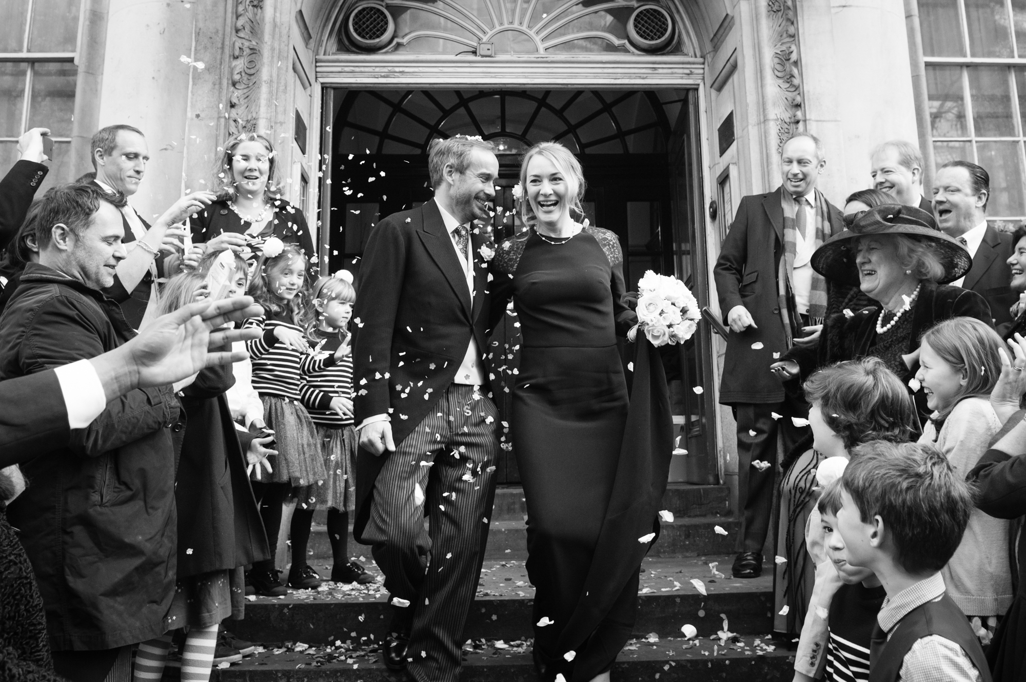 wedding party on steps at chelsea town hall during their small london city wedding
